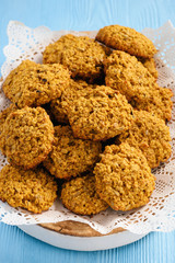Soft pumpkin oatmeal cookies on blue wooden background.