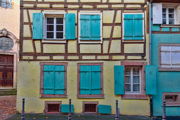 Blue windows on pale yellow walls of a small town