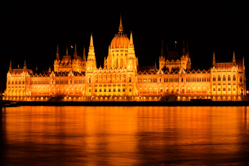 Fototapeta na wymiar Hungarian Parliament by Night with Reflection on Danube River
