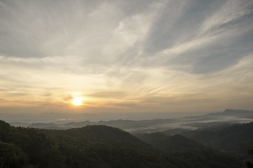 Beautiful mountain landscape, with mountain peaks covered with forest and a cloudy sky