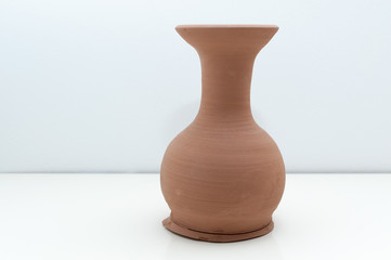 handmade clay vase with white background