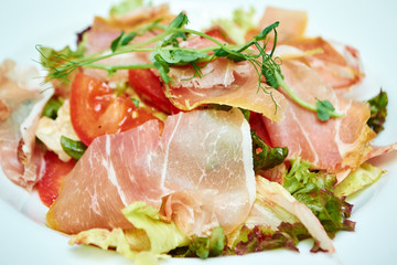 salad of arugula ham cheese on a white background