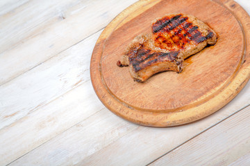 Grilled meat on wooden board