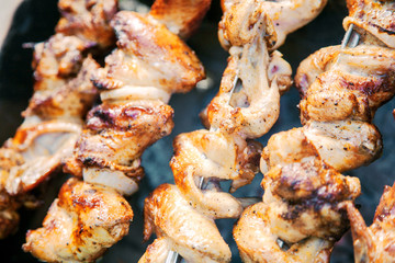 Chicken wings grilled on a coals