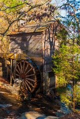 Fototapeta na wymiar Grist Mill and the creek in the Stone Mountain Park in sunny autumn day, Georgia, USA 