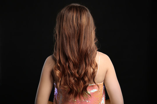 Woman with caramel highlights on black background