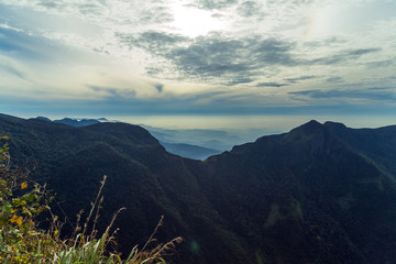 Sunrise in meadows and mountains landscape, Worlds End in Horton Plains National Park Sri Lanka.