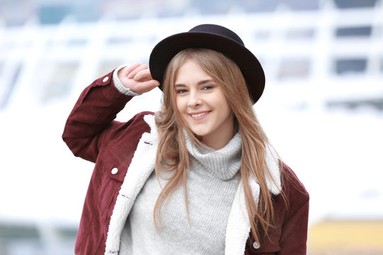 Attractive hipster girl in hat outdoors