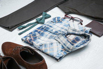 Set of hipster clothes and accessories on light background