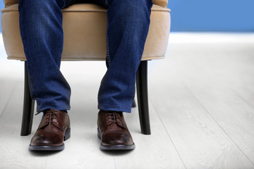 Man in elegant leather shoes indoors, closeup