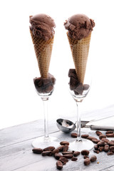 chocolate ice cream scoops with pieces of chocolate and waffle cones