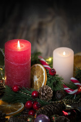 A Couple of Christmas decorated Burning candles on dark wooden rustic background with Copy space 5