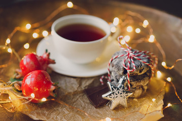 cup of tea, a garland, a tray,  chocolate, pomegranate