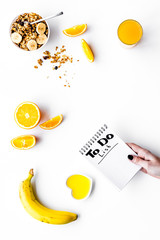 Morning habits of successful people. Healthy breakfast porridge with fruits and planning the day. White background top view