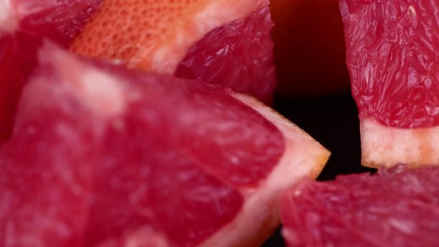 Portion of fresh Grapefruit rotating on a plate (seamless loopable; 4K)