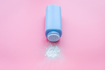 Hypoallergenic bath cosmetics for kids with lavender. Bottle of powder on pink background copyspace