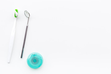 Healty teeth. Toothbrushes and dental mirror on white background top view copyspace