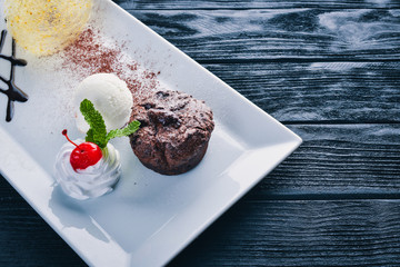 Chocolate ice cream cake. On a wooden background. Free space for your text. Top view.