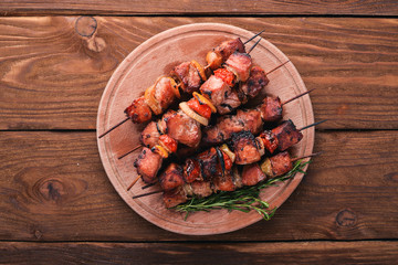 Marinated baked kebab with onions and spices. On a wooden background. Top view. Free space for text.