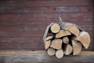 Basket with firewood on wooden background