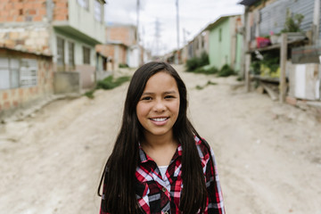 Portrait of beautiful girl in shanty town.