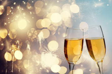Champagne glasses on sparkling background