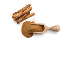 Cinnamon sticks and powder in a wooden scoop