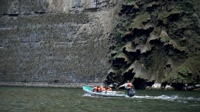 driving on boat, touristic boat riding near canyon wall with natural cascade form, tour in the Sumidero Canyon - Chiapas, Mexico
