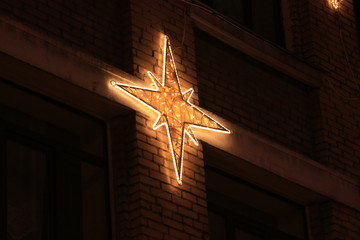 Naklejka premium glowing snowflake on the facade