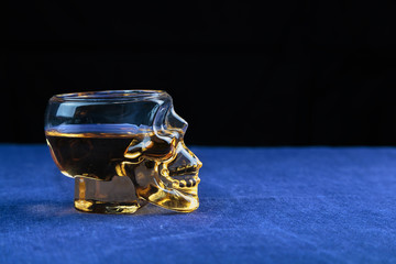 strong alcoholic drink poured into a glass made in the shape of the skull