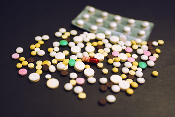 tablets and pills on dark background