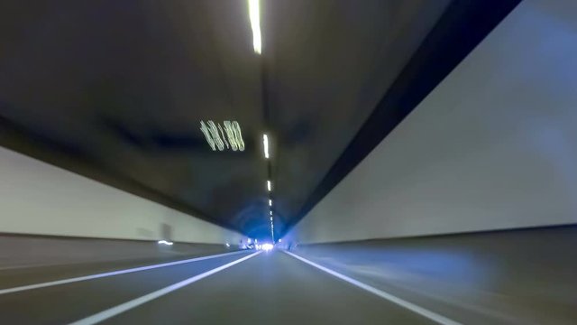Circulating quickly through (up) a tunnel of two directions and at the end you come to the exit with fade in white. Time Lapse - Vehicle shot - Point of view,Tunnel of "CADI"province of BARCELONA,