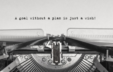 A goal without a plan is just a wish! close up, typed words on a vintage typewriter with vintage...