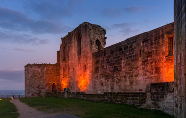 Beautiful sunset on ancient Stafford Castle with colorful sky and light on castle.