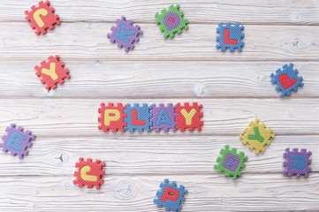 play puzzle on a wooden background