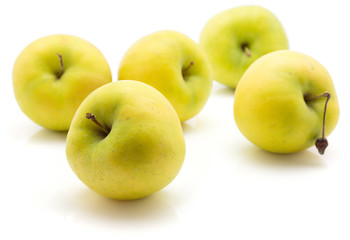 Apples (Smeralda variety) isolated on white background five whole green yellow.