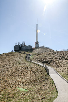 Antenna on a volcano mountain in France with path in the foreground