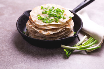 Indian flatbread chapati, green onion. Color surge trend.