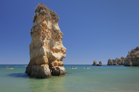 Praia da Dona Ana beach, group of kayaks on a trip to Ponta da Piedade Cape, Lagos, Algarve, Portugal