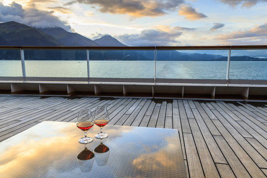 Glowing cognac (brandy) reflections, glass table at sunset, cruise ship stern, Resurrection Bay, Kenai Peninsula, Alaska