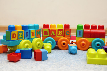 Toy train. Grandmothers day lettering with blocks. Napis z kolorowych klocków: Dzień Babci.