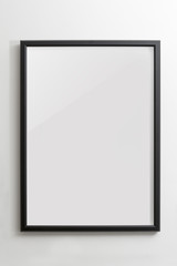 Wooden black empty frame on white wall