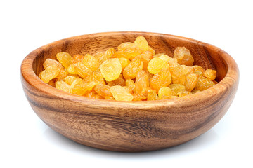 Wooden bowl with golden raisins.