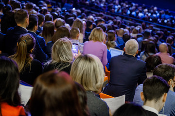 People attend business conference in the congress hall