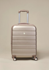 Small golden trolley suitcase isolated