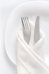 Fork and knife on white plate