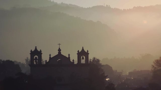 aerial citiview silhouette of catholic church, street and hills,  ancient town  San Cristobal de las Casas