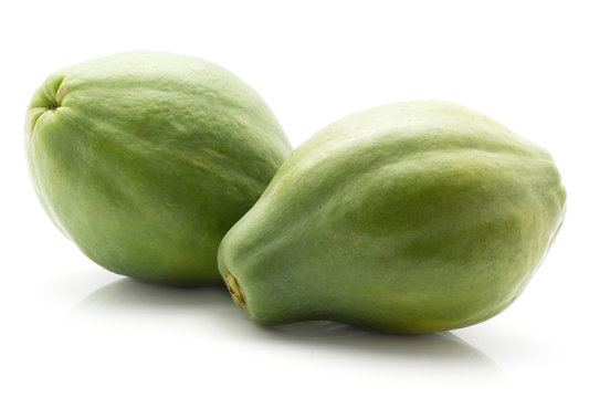 Two green papaya (pawpaw, papaw) isolated on white background.
