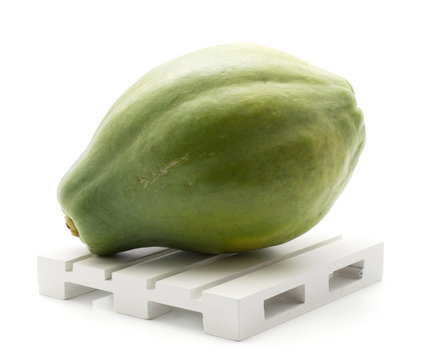 Green papaya (pawpaw, papaw) on a pallet isolated on white background fresh one.