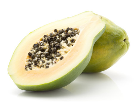 Papaya (pawpaw, papaw) isolated on white background one whole green cross section half with seeds.